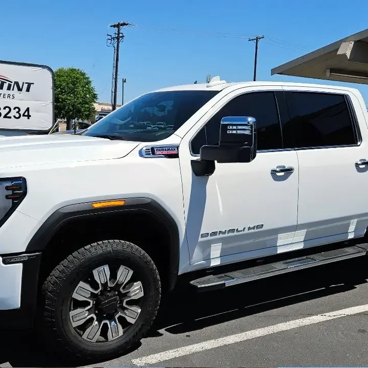 White GMC Sierra 2500HD Denali with freshly tinted windows, outside the King Auto Tint shop on Fulton Ave in Sacramento
