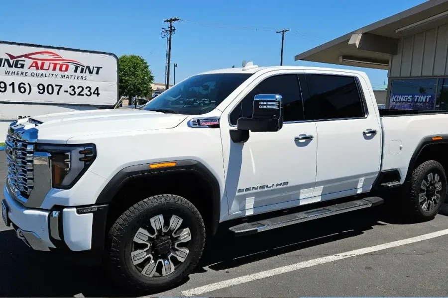 White GMC Sierra 2500HD Denali with freshly tinted windows, outside the King Auto Tint shop on Fulton Ave in Sacramento