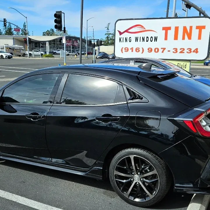 Black Honda Civic with freshly tinted windows, photographed after its tint job at King Window Tint in Sacramento, view 2