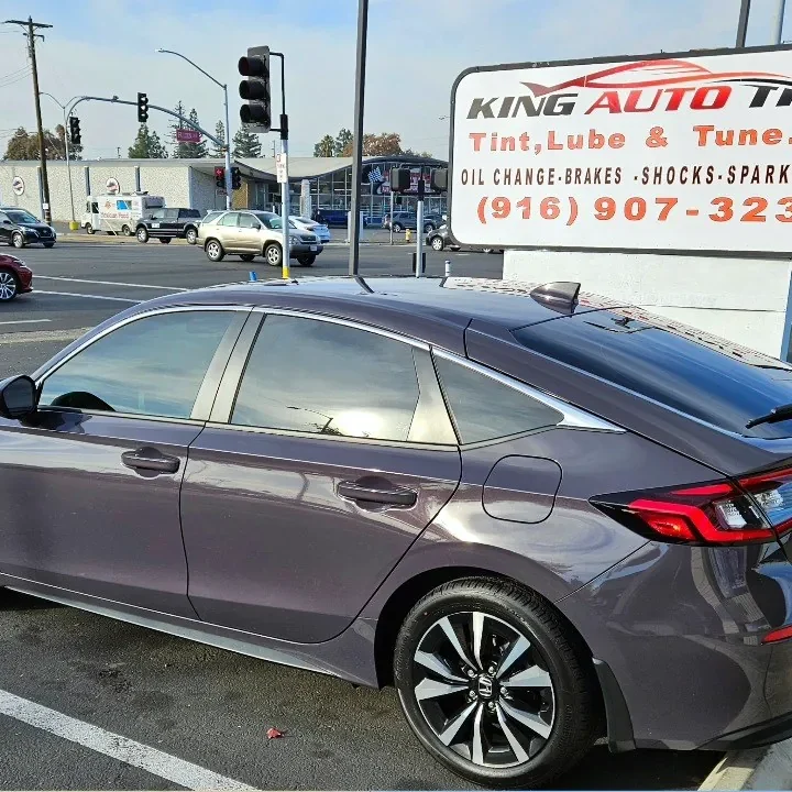 Gray Honda Civic with freshly tinted windows, in the King Auto Tint parking lot on Fulton Avenue, Sacramento