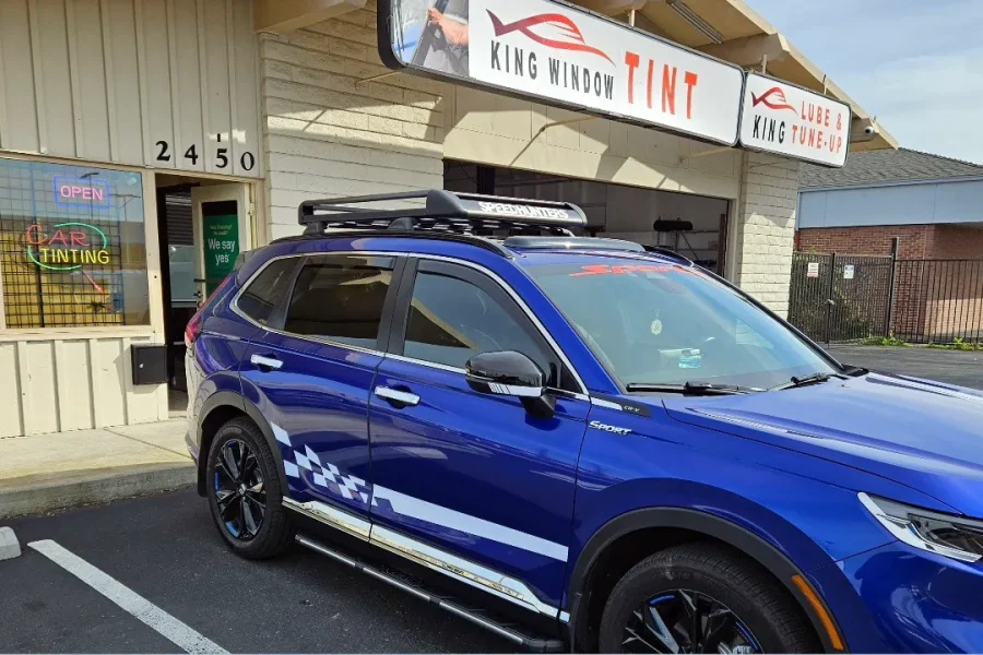 Blue Honda CR-V with freshly tinted windows, in the King Window Tint parking lot on Fulton Avenue, Sacramento