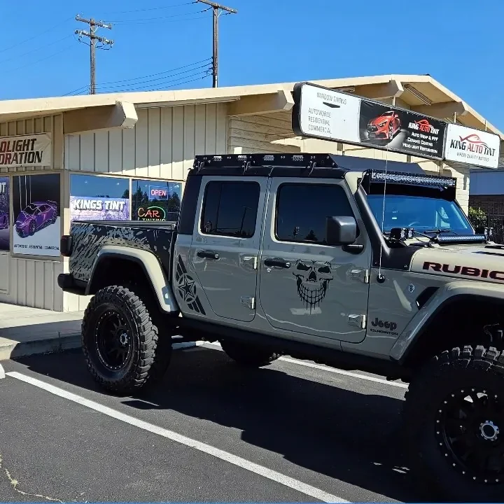 Tan Jeep Gladiator Rubicon with freshly tinted windows, in the King Auto Tint parking lot on Fulton Avenue, Sacramento (lifted)