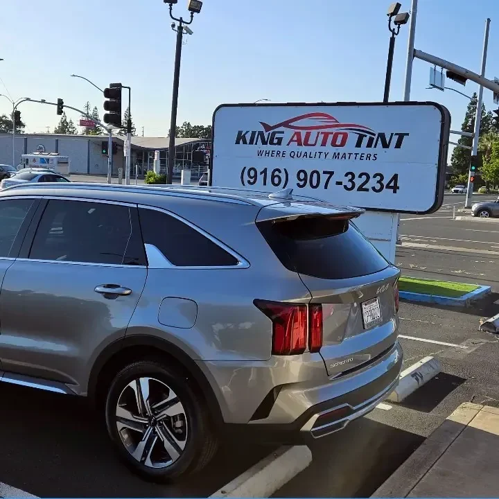 Silver Kia Sorento with freshly tinted windows, parked in front of King Auto Tint at 2450 Fulton Ave, Sacramento