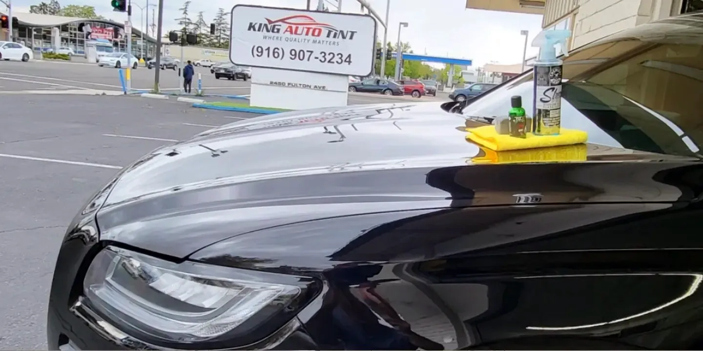 Black Lincoln Continental after a ceramic coating, parked in front of King Auto Tint at 2450 Fulton Ave, Sacramento