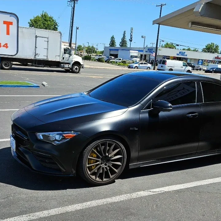 Matte black Mercedes-AMG CLA 45 with freshly tinted windows, outside the King Window Tint shop on Fulton Ave in Sacramento