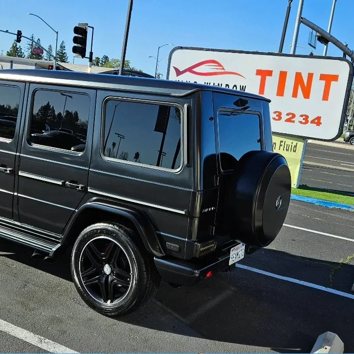Black Mercedes-AMG G 63 with freshly tinted windows, in the King Window Tint parking lot on Fulton Avenue, Sacramento
