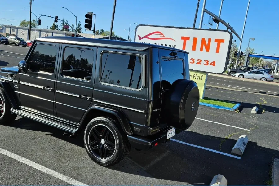 Black Mercedes-AMG G 63 with freshly tinted windows, in the King Window Tint parking lot on Fulton Avenue, Sacramento