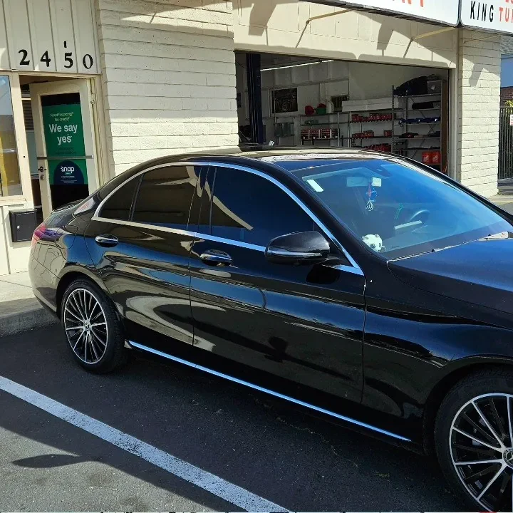 Black Mercedes-Benz C 300 with freshly tinted windows, outside the King Window Tint shop on Fulton Ave in Sacramento