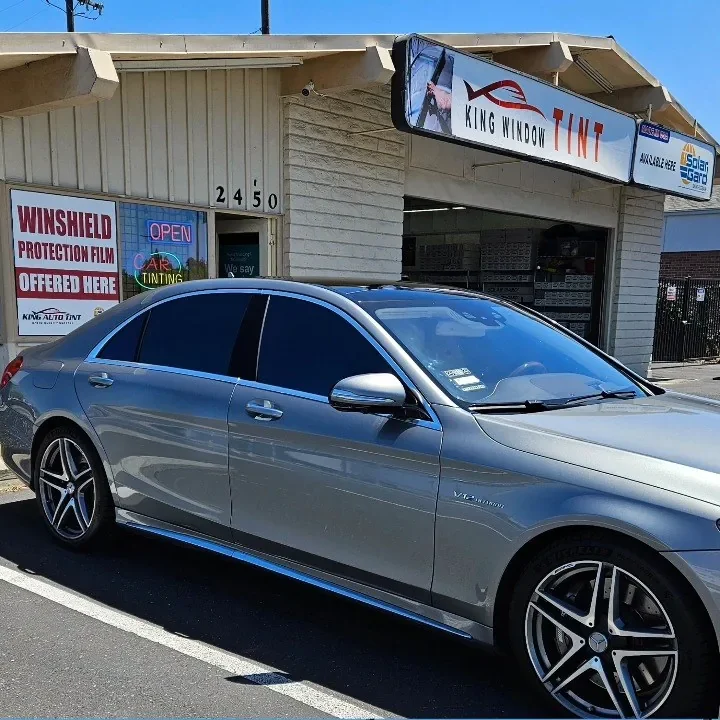 Silver Mercedes-Benz S-Class with freshly tinted windows, outside the King Window Tint shop on Fulton Ave in Sacramento