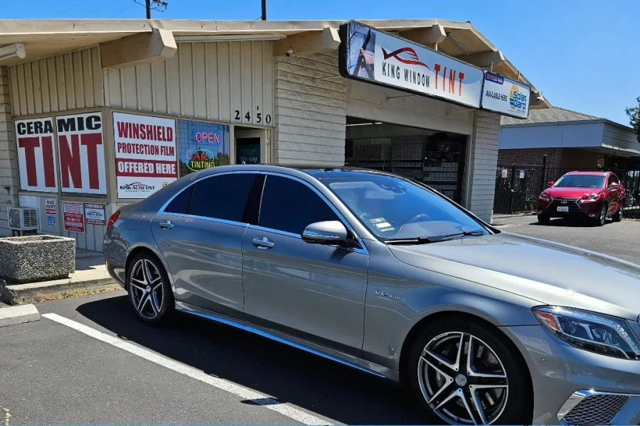 Silver Mercedes-Benz S-Class with freshly tinted windows, outside the King Window Tint shop on Fulton Ave in Sacramento