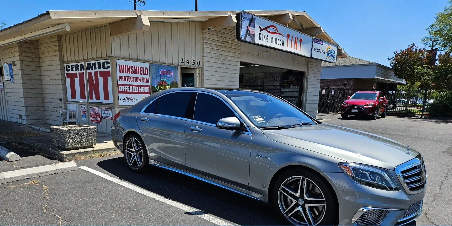 Silver Mercedes-Benz S-Class with freshly tinted windows, outside the King Window Tint shop on Fulton Ave in Sacramento