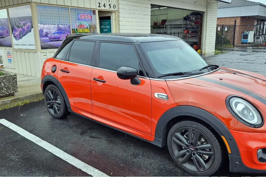 Orange MINI Cooper with freshly tinted windows, photographed after its tint job at King Window Tint in Sacramento
