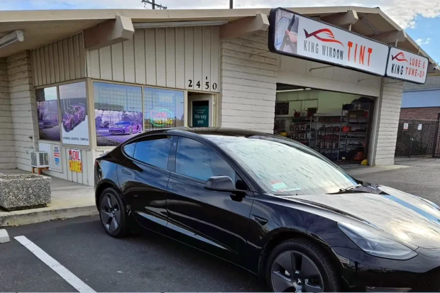 Black Tesla Model 3 with freshly tinted windows, parked in front of King Window Tint at 2450 Fulton Ave, Sacramento