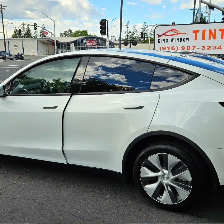 White Tesla Model Y with freshly tinted windows, photographed after its tint job at King Window Tint in Sacramento