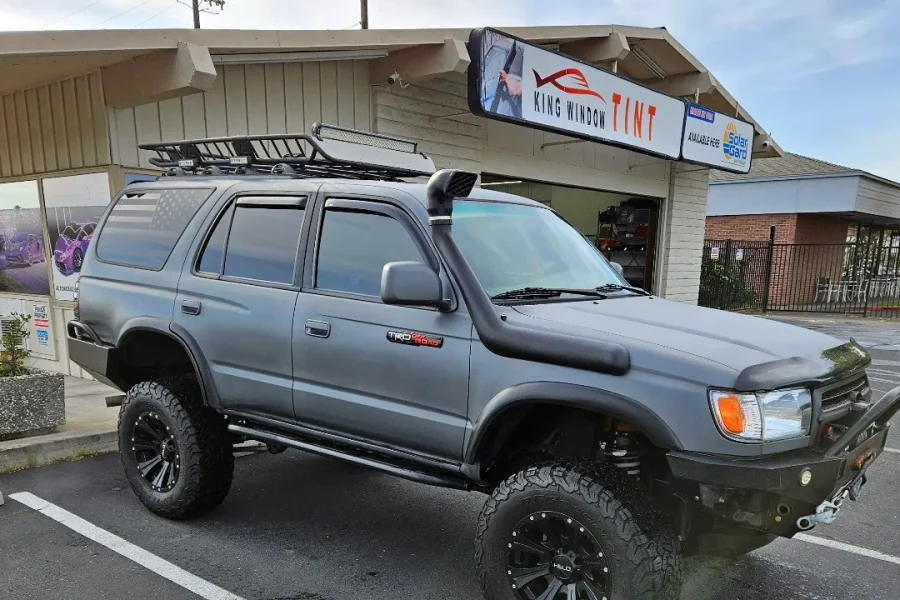 Gray Toyota 4Runner with freshly tinted windows, in the King Window Tint parking lot on Fulton Avenue, Sacramento (lifted, third generation)