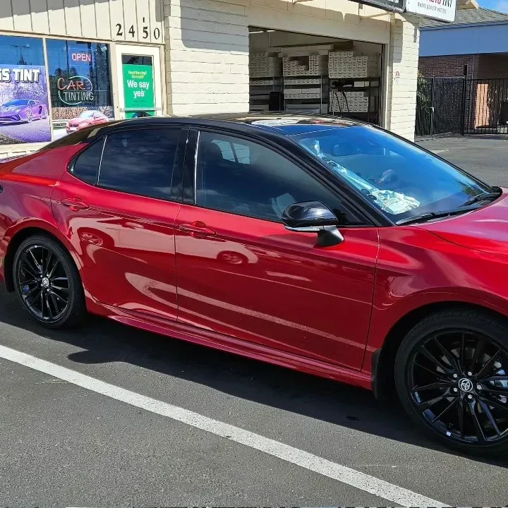 Red Toyota Camry XSE with freshly tinted windows, photographed after its tint job at King Auto Tint in Sacramento