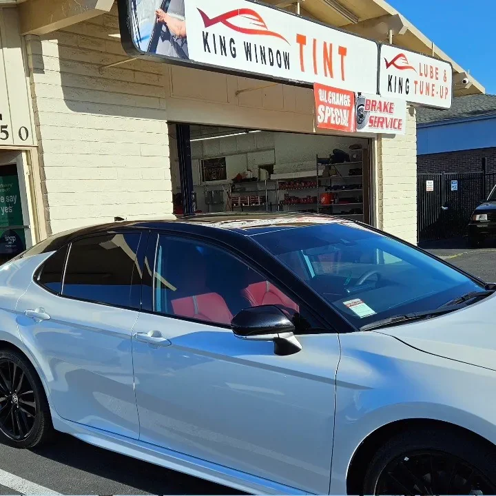 White Toyota Camry XSE with freshly tinted windows, parked in front of King Window Tint at 2450 Fulton Ave, Sacramento