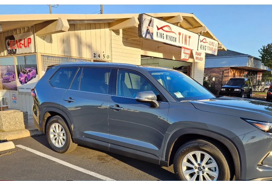 Gray Toyota Grand Highlander with freshly tinted windows, parked in front of King Window Tint at 2450 Fulton Ave, Sacramento