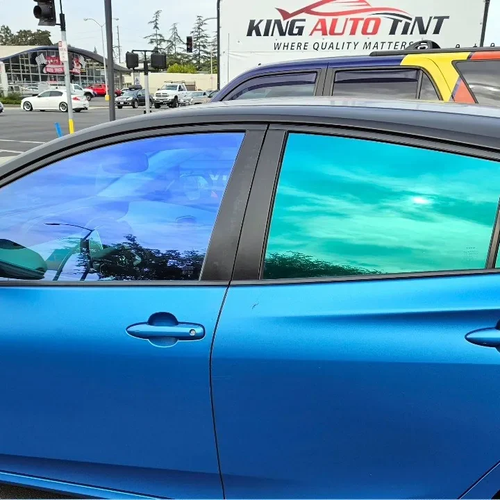 Blue Toyota Prius with freshly tinted windows, parked in front of King Auto Tint at 2450 Fulton Ave, Sacramento (iridescent-look window tint)