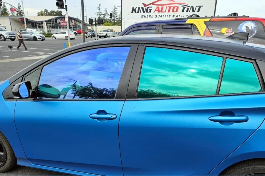 Blue Toyota Prius with freshly tinted windows, parked in front of King Auto Tint at 2450 Fulton Ave, Sacramento (iridescent-look window tint)