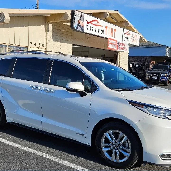 White Toyota Sienna with freshly tinted windows, parked in front of King Window Tint at 2450 Fulton Ave, Sacramento