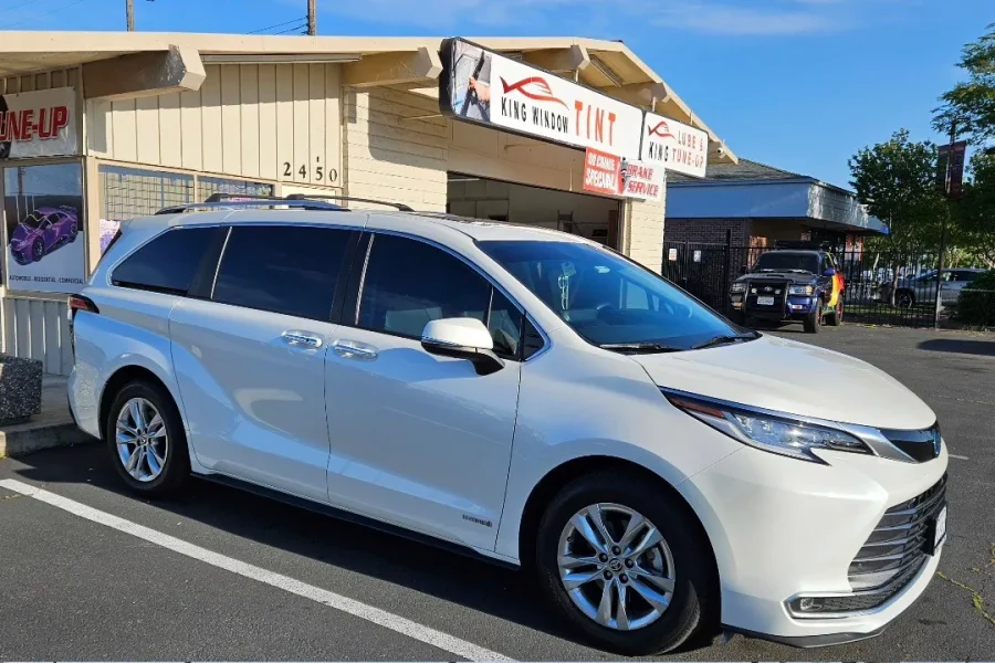 White Toyota Sienna with freshly tinted windows, parked in front of King Window Tint at 2450 Fulton Ave, Sacramento