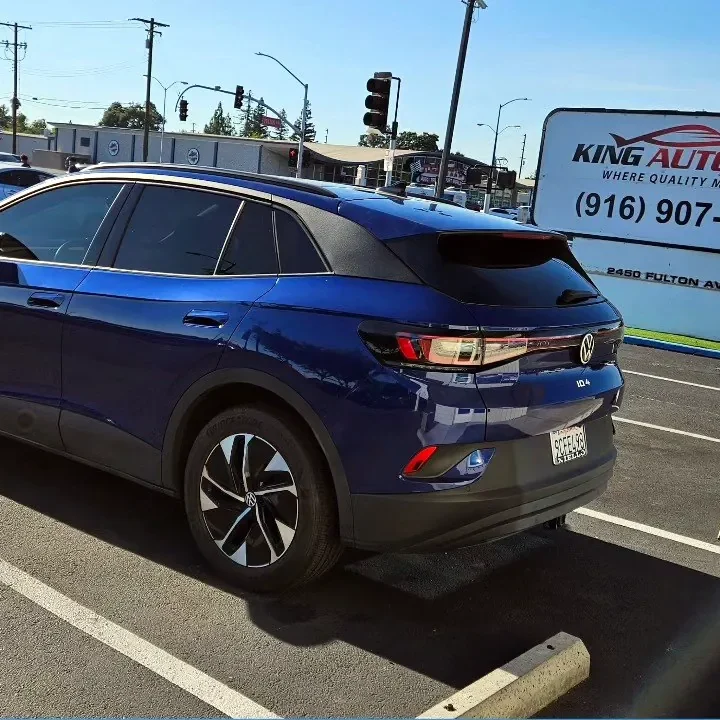 Blue Volkswagen ID.4 with freshly tinted windows, outside the King Auto Tint shop on Fulton Ave in Sacramento